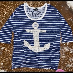 This shirt is a blue/white striped shirt with an anchor on the front